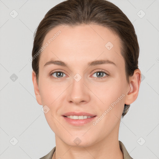 Joyful white young-adult female with short  brown hair and grey eyes