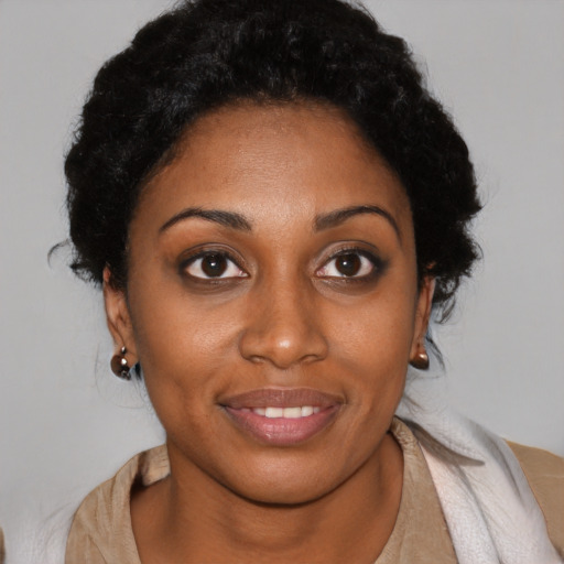 Joyful black young-adult female with short  brown hair and brown eyes