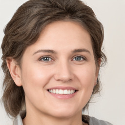 Joyful white young-adult female with medium  brown hair and grey eyes