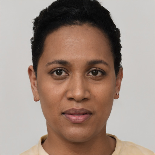 Joyful latino young-adult female with short  black hair and brown eyes