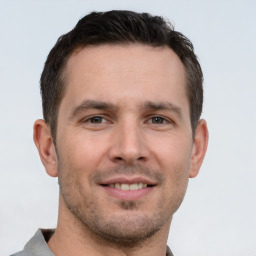 Joyful white young-adult male with short  brown hair and brown eyes