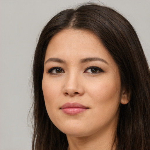 Joyful asian young-adult female with long  brown hair and brown eyes