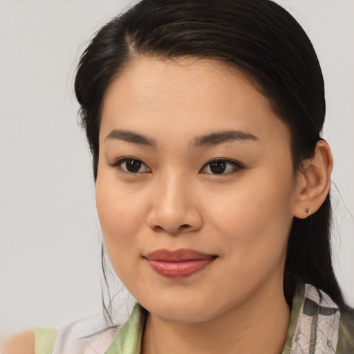 Joyful asian young-adult female with medium  brown hair and brown eyes