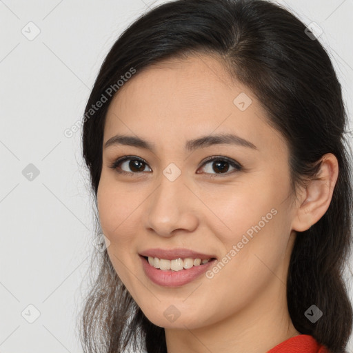 Joyful white young-adult female with long  brown hair and brown eyes