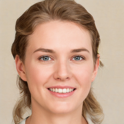 Joyful white young-adult female with medium  brown hair and blue eyes