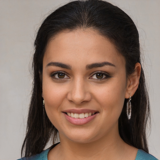 Joyful latino young-adult female with medium  brown hair and brown eyes