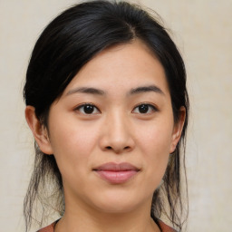 Joyful asian young-adult female with medium  brown hair and brown eyes