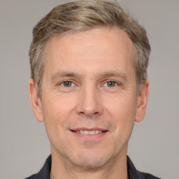 Joyful white adult male with short  brown hair and grey eyes