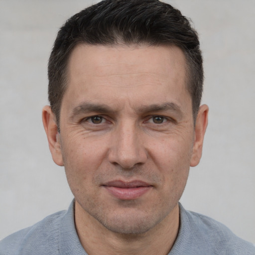 Joyful white adult male with short  brown hair and brown eyes