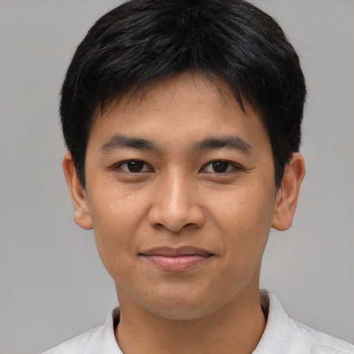 Joyful asian young-adult male with short  black hair and brown eyes