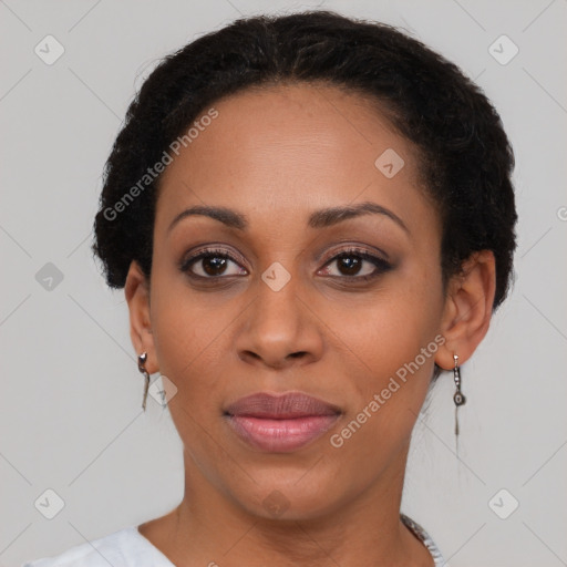 Joyful black young-adult female with short  black hair and brown eyes