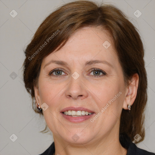 Joyful white adult female with medium  brown hair and grey eyes