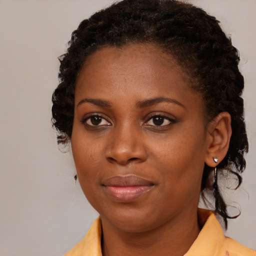 Joyful black young-adult female with medium  brown hair and brown eyes