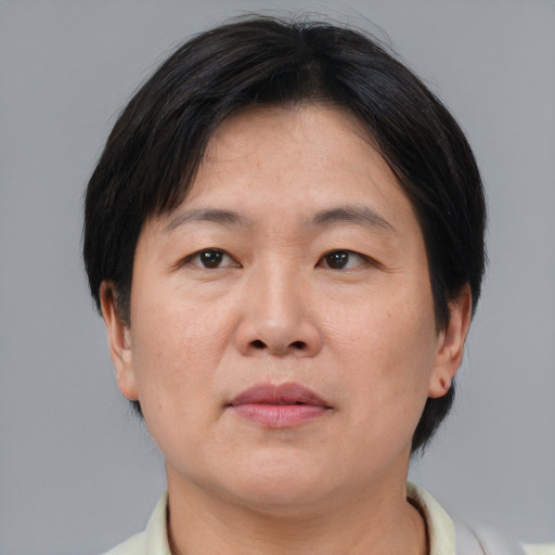 Neutral asian adult female with short  brown hair and brown eyes