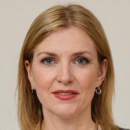 Joyful white adult female with medium  brown hair and grey eyes