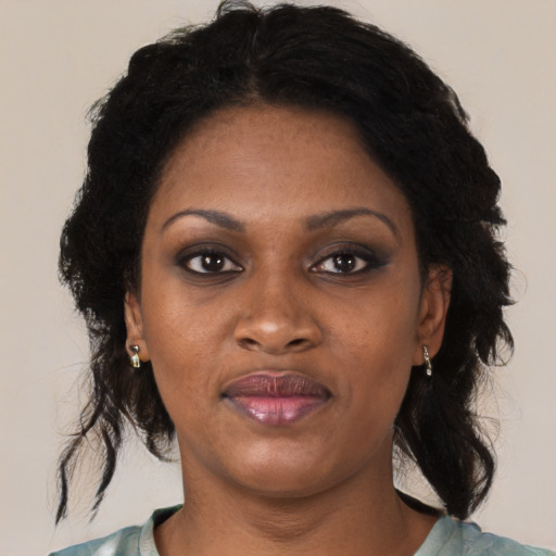 Joyful black young-adult female with medium  brown hair and brown eyes