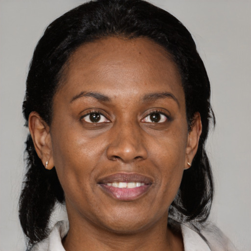 Joyful black adult female with medium  black hair and brown eyes