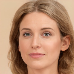 Joyful white young-adult female with long  brown hair and green eyes