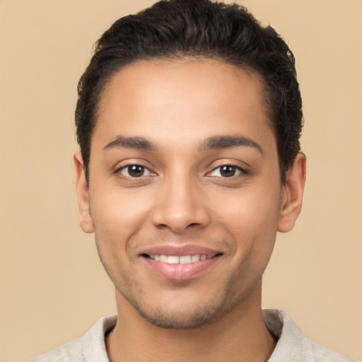 Joyful latino young-adult male with short  brown hair and brown eyes