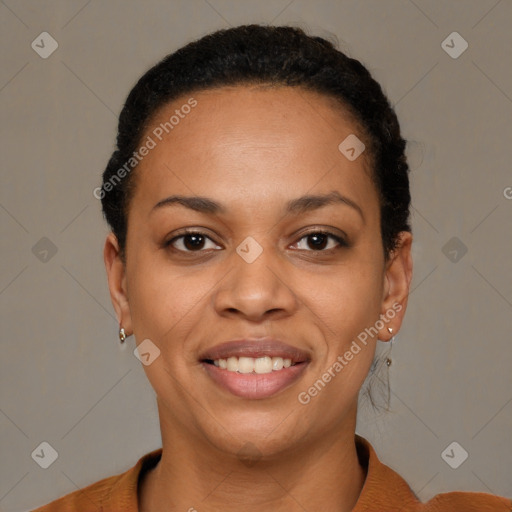 Joyful black young-adult female with short  black hair and brown eyes