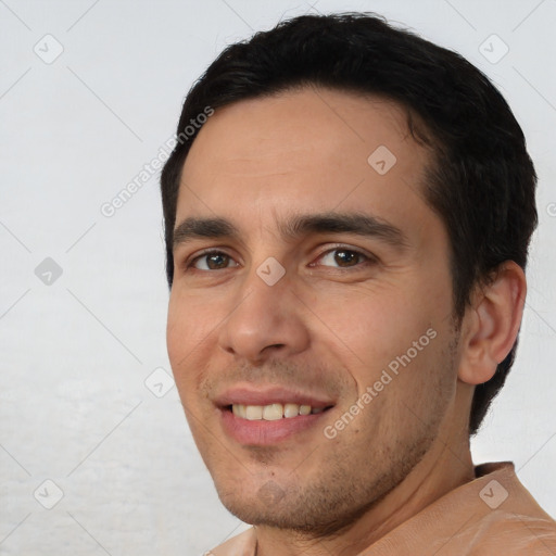 Joyful white young-adult male with short  black hair and brown eyes