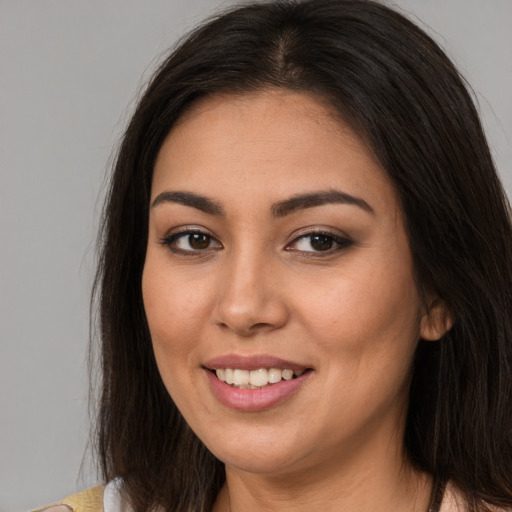 Joyful asian young-adult female with long  brown hair and brown eyes