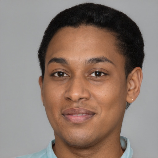 Joyful black young-adult male with short  brown hair and brown eyes
