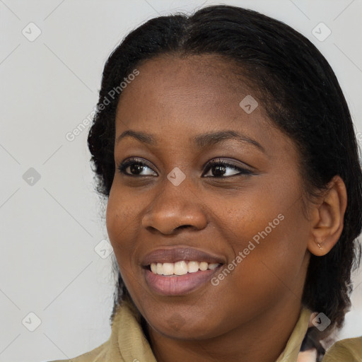 Joyful black young-adult female with long  brown hair and brown eyes