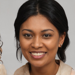 Joyful black young-adult female with medium  brown hair and brown eyes