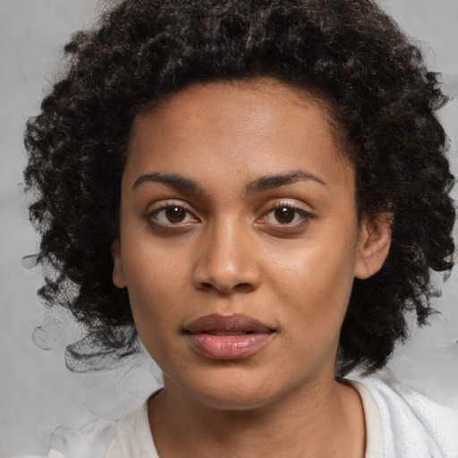 Joyful black young-adult female with medium  black hair and brown eyes