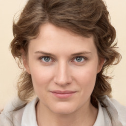 Joyful white young-adult female with medium  brown hair and blue eyes