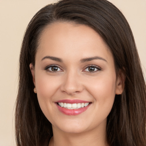 Joyful white young-adult female with long  brown hair and brown eyes