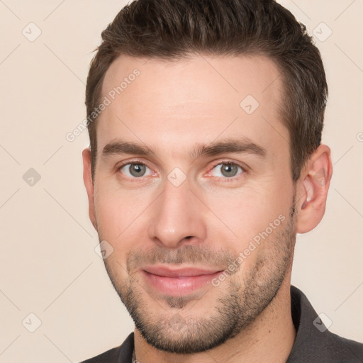 Joyful white young-adult male with short  brown hair and brown eyes