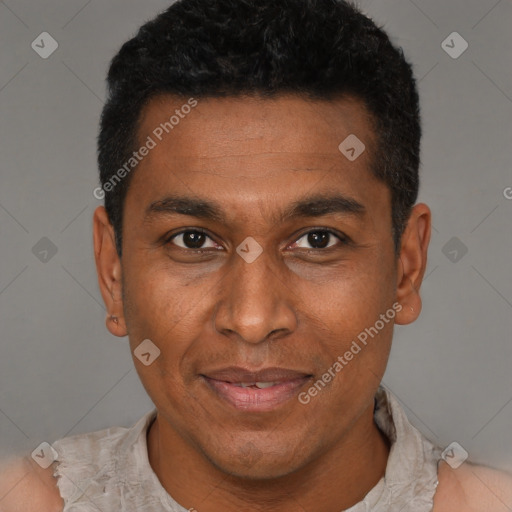 Joyful black adult male with short  black hair and brown eyes