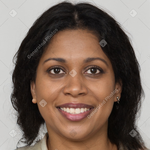 Joyful black young-adult female with long  brown hair and brown eyes