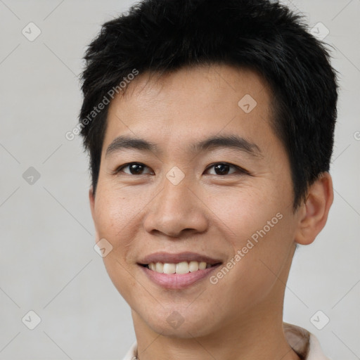 Joyful asian young-adult male with short  brown hair and brown eyes