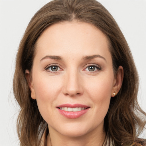 Joyful white young-adult female with long  brown hair and grey eyes