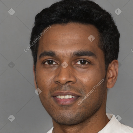 Joyful latino young-adult male with short  black hair and brown eyes