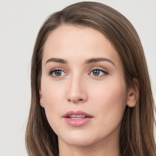 Joyful white young-adult female with long  brown hair and grey eyes