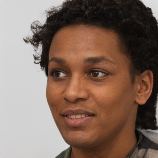 Joyful black young-adult female with short  black hair and brown eyes