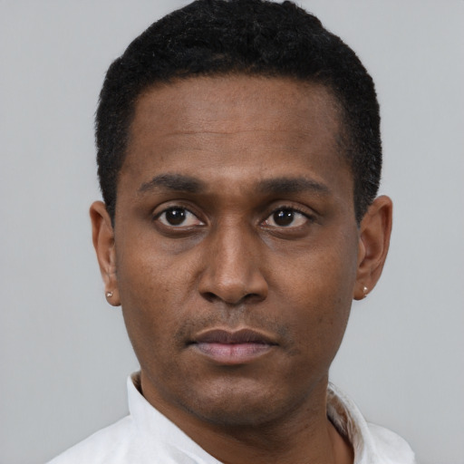 Neutral latino young-adult male with short  black hair and brown eyes