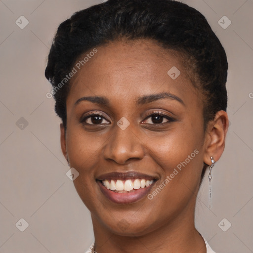 Joyful black young-adult female with short  black hair and brown eyes