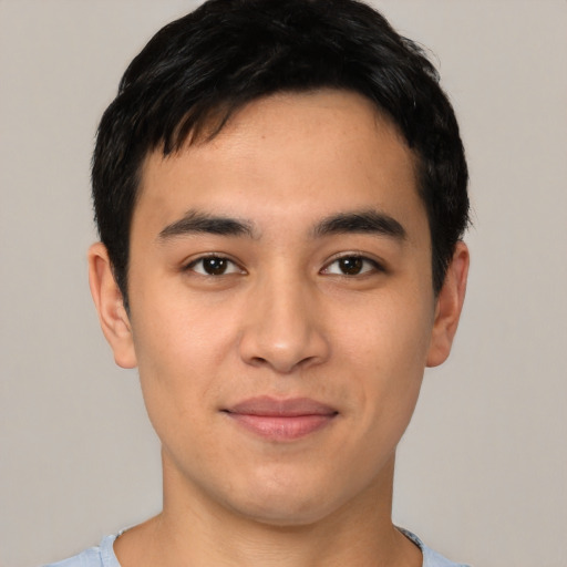 Joyful asian young-adult male with short  black hair and brown eyes