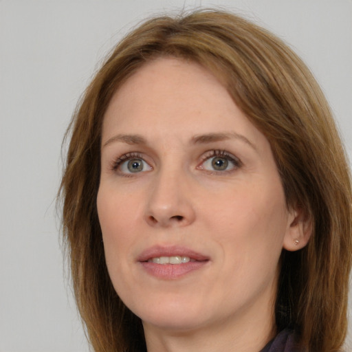 Joyful white young-adult female with long  brown hair and green eyes