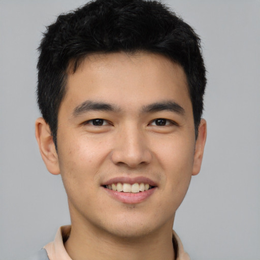 Joyful asian young-adult male with short  brown hair and brown eyes