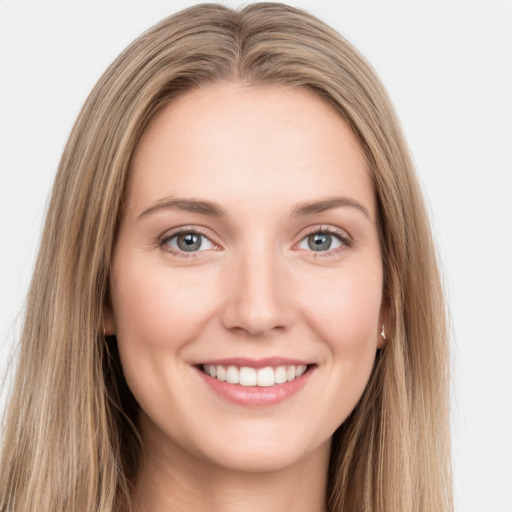 Joyful white young-adult female with long  brown hair and green eyes