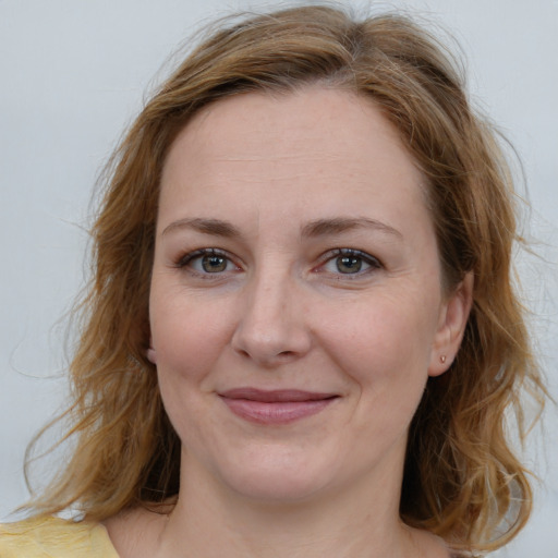 Joyful white adult female with medium  brown hair and blue eyes