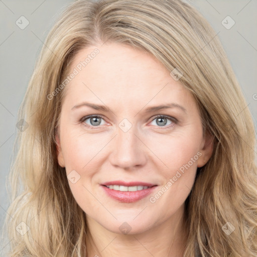 Joyful white young-adult female with long  brown hair and blue eyes