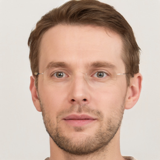 Joyful white young-adult male with short  brown hair and grey eyes