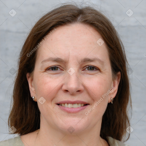 Joyful white adult female with medium  brown hair and grey eyes